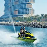 Guided jetski tour with guest drifting on water next to royal atlantis.