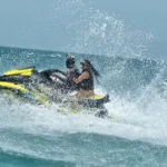 Guided jetski tour with guest drifting on water.