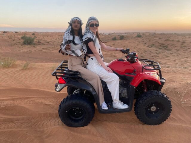 girls on a quad bike in dubai desert